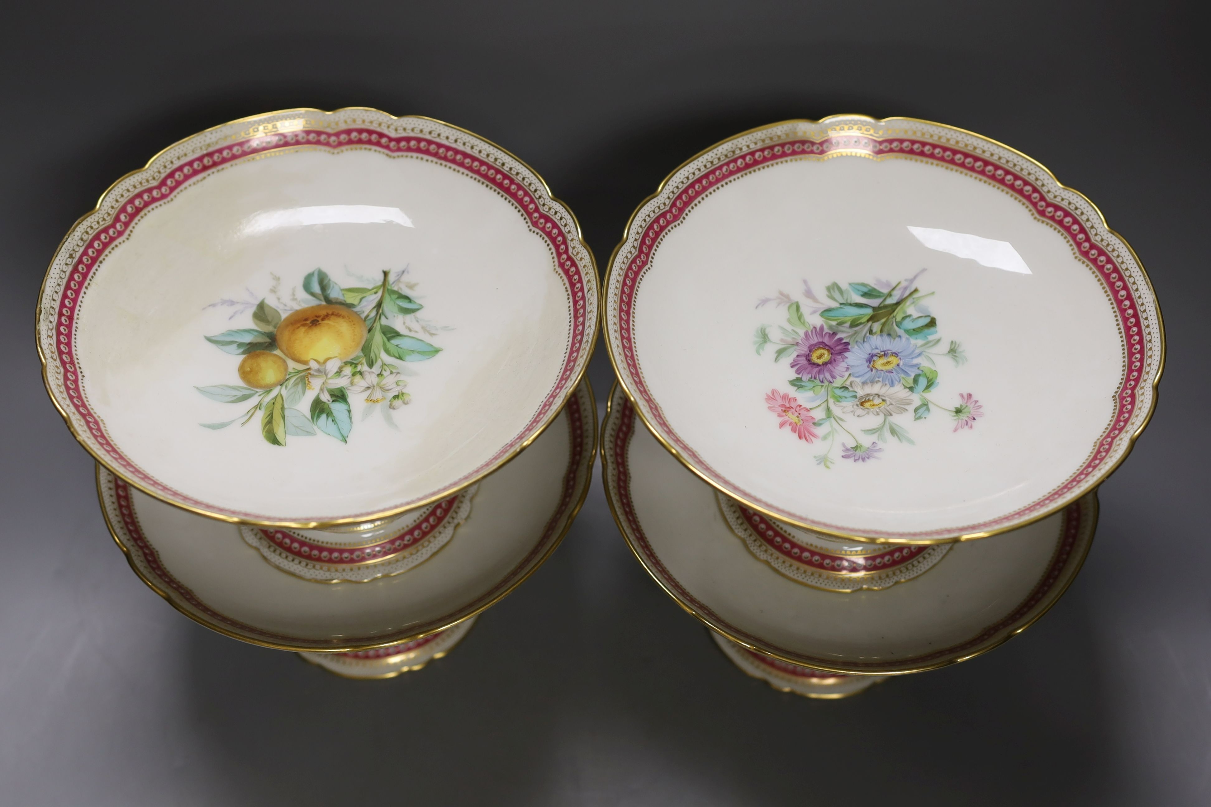 A late 19th century Paris porcelain floral part dessert service, with 2 pairs of comports, a three tier cake stand and eleven dishes.